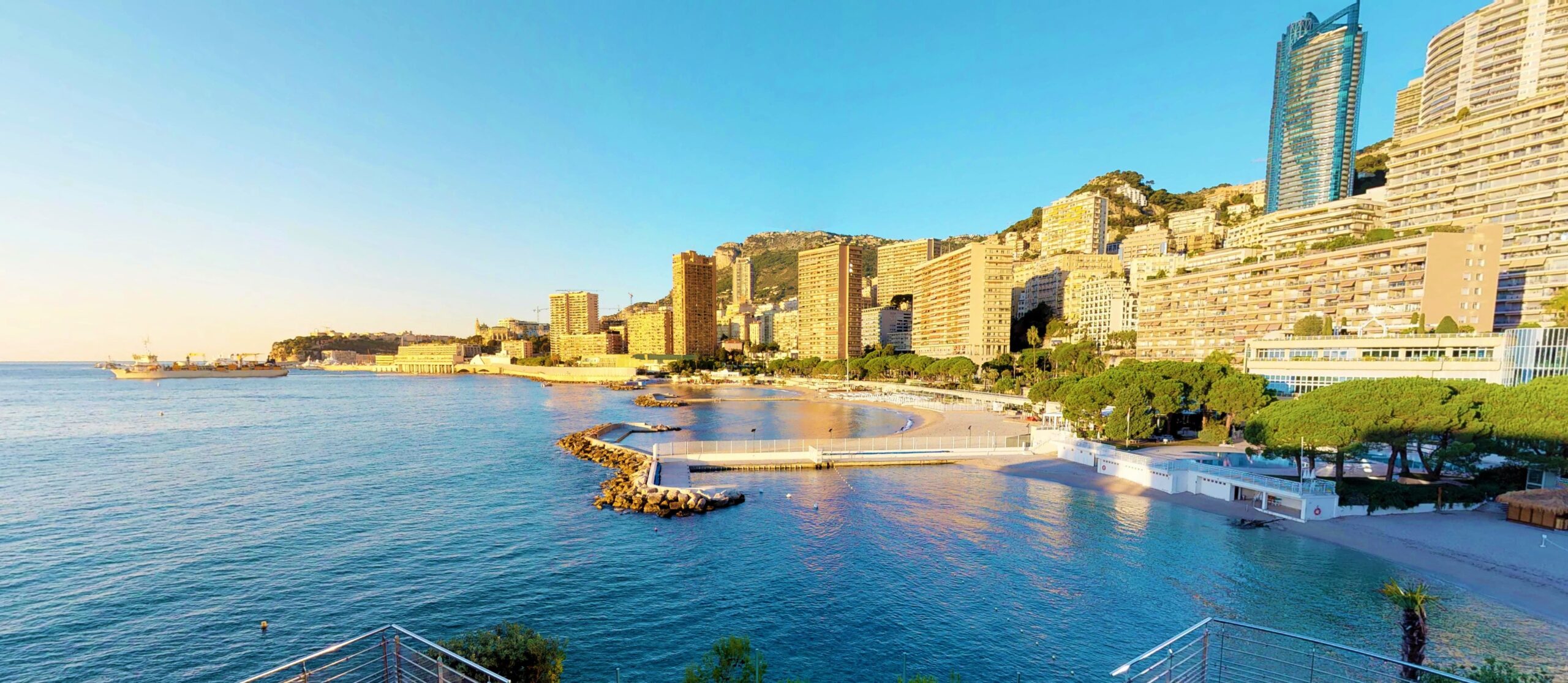 Larvotto Beach and Monaco coastline with Tour Odéon skyline