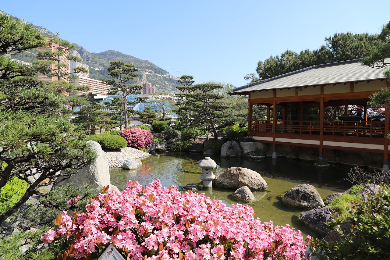 Japanese Garden in Larvotto, flowers in bloom, real estate behind
