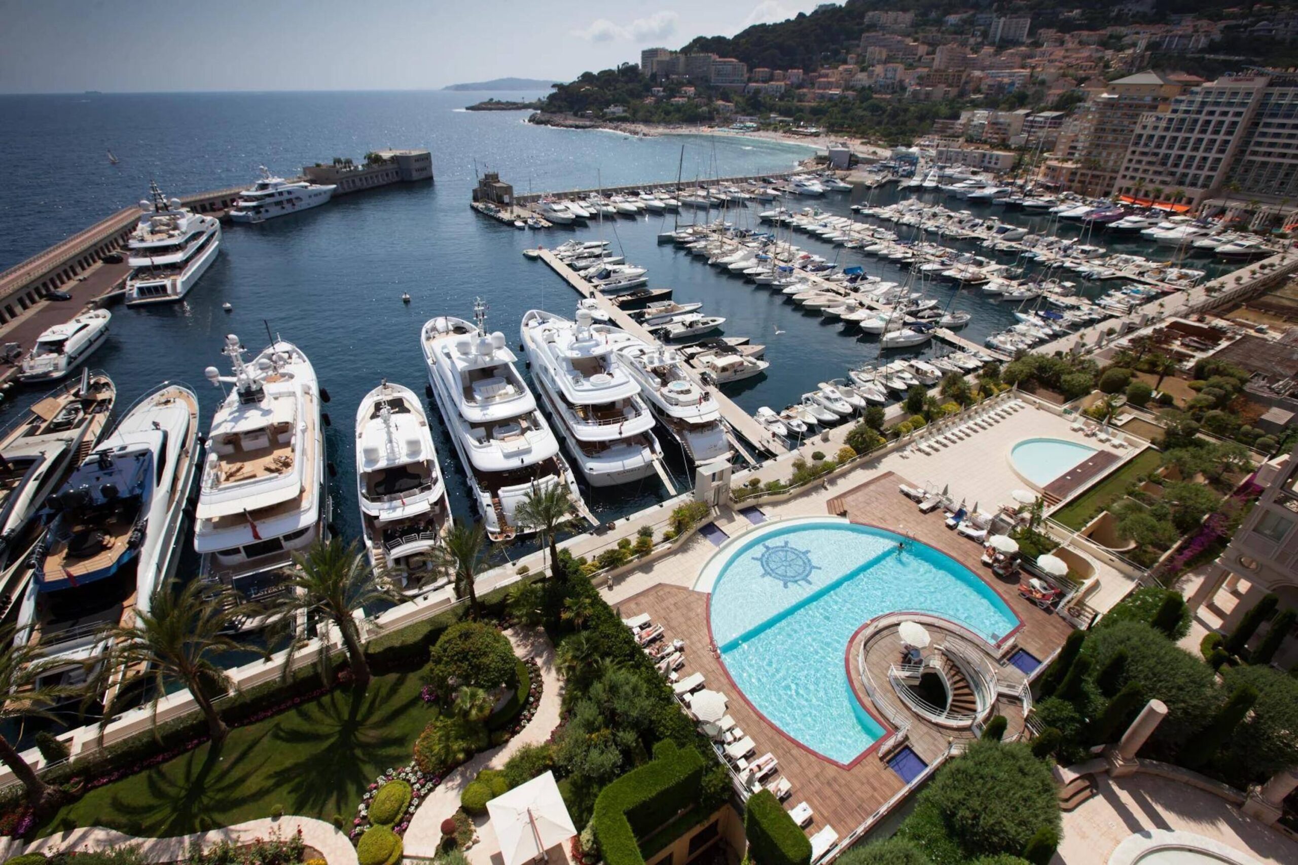 View over Monaco harbour with yachts and the Palazzo Leonardo swimming pool terrace overlooking the marina