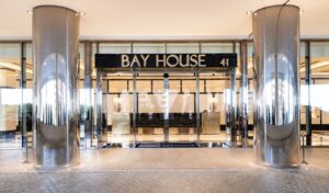 Bay House Monaco main entrance with illuminated signage and glass doors at 41 Boulevard d’Italie