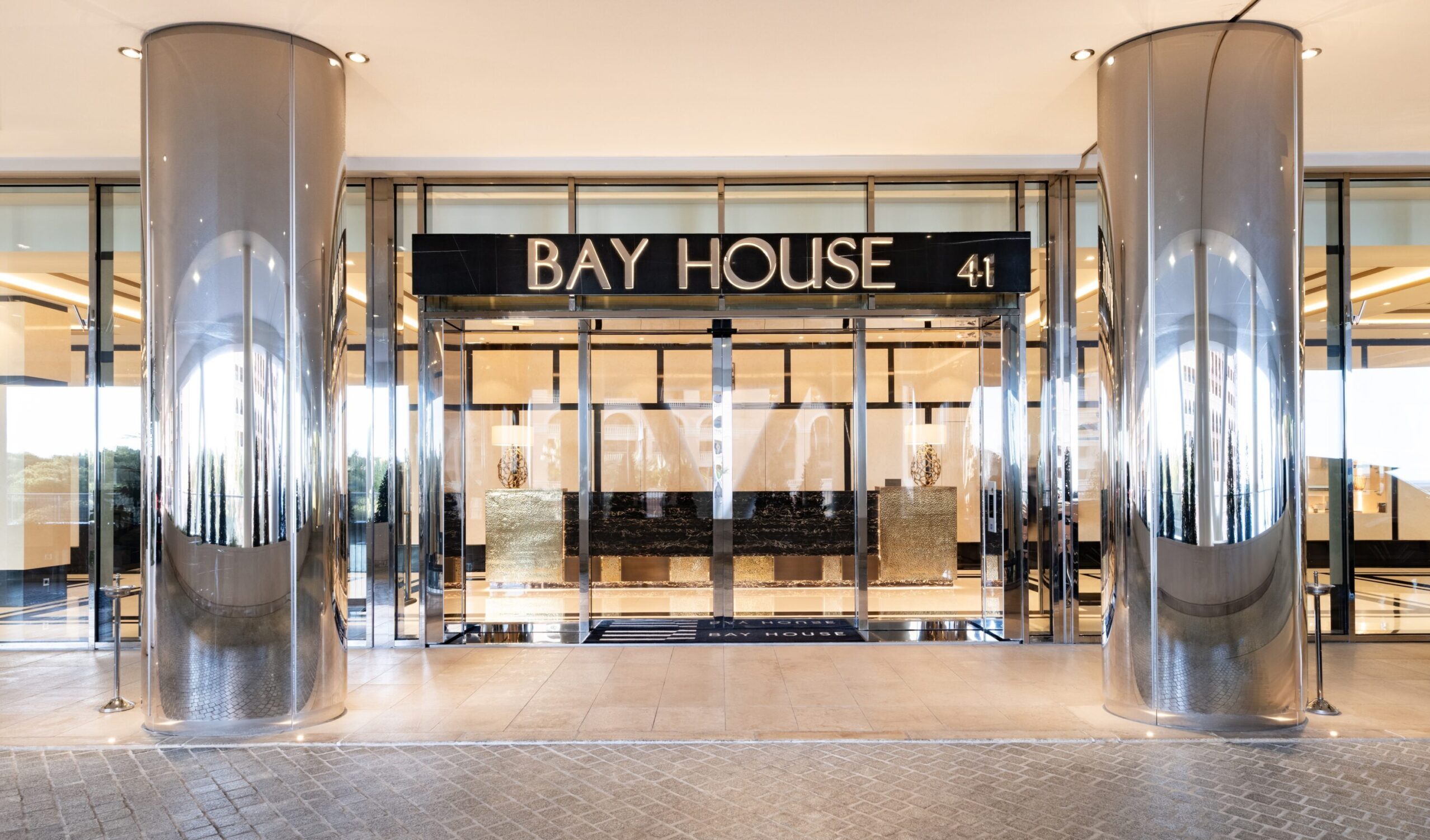 Bay House Monaco main entrance with illuminated signage and glass doors at 41 Boulevard d’Italie